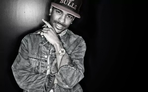 HD desktop wallpaper featuring a stylized black and white portrait of a man in a denim jacket and a Bulls cap, posing with a finger on his chin.