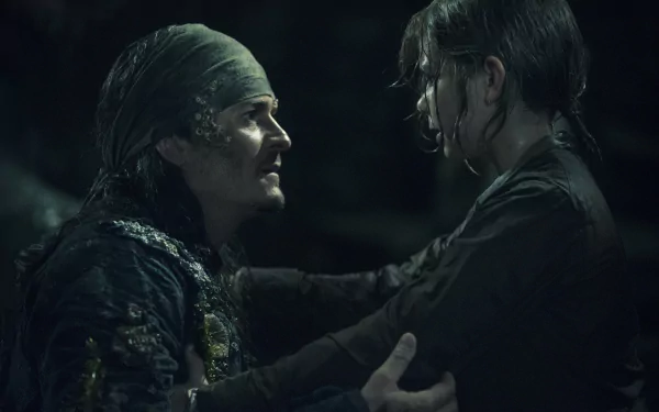 Henry Turner and Will Turner, played by Orlando Bloom, in a dark, intense scene from Pirates of the Caribbean: Dead Men Tell No Tales, shown in 4K Ultra HD desktop wallpaper.