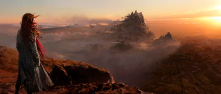 A stunning HD desktop wallpaper from the fantasy movie Mortal Engines, featuring Hera Hilmar against a steampunk cityscape under a dramatic horizon, with clouds and an expansive landscape.