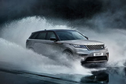Silver Land Rover Range Rover SUV driving through water splashes, captured in 4K Ultra HD, serving as a striking PC desktop wallpaper and background.
