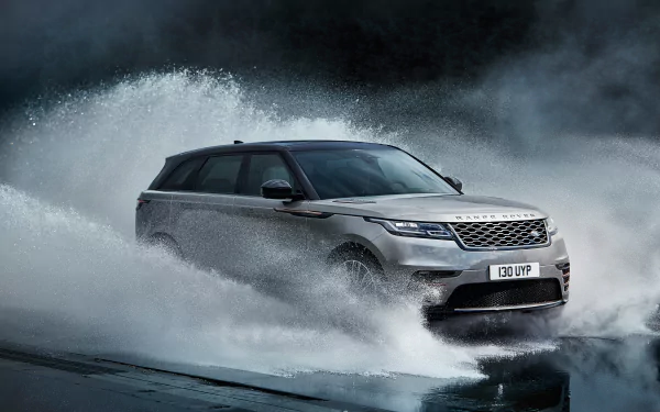 Silver Land Rover Range Rover SUV driving through water splashes, captured in 4K Ultra HD, serving as a striking PC desktop wallpaper and background.