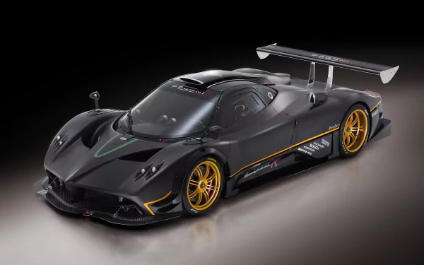 HD desktop wallpaper featuring the sleek and powerful Pagani Zonda R supercar in black, showcasing its impressive aerodynamic design and golden wheels against a dark background.