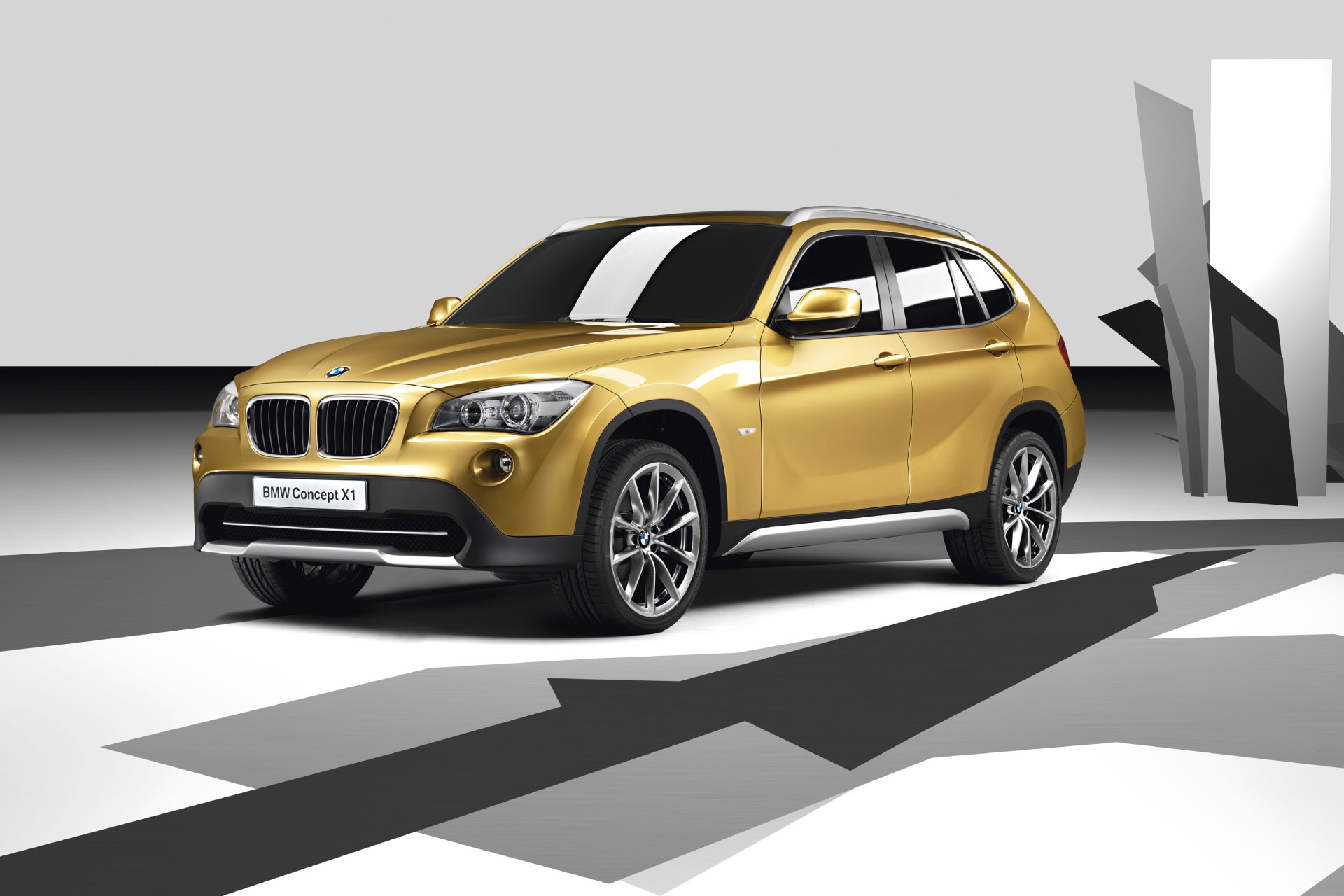 Yellow BMW X1 SUV showcased in a modern, minimalist setting as an HD PC desktop wallpaper background.