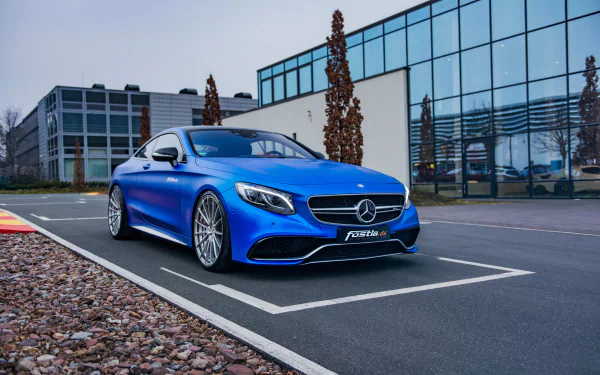A striking blue Mercedes-Benz S63 AMG parked in front of a modern glass building, captured in high definition for a PC desktop wallpaper and background.
