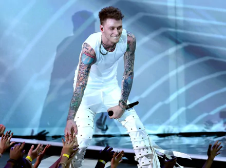 HD desktop wallpaper of a tattooed performer interacting with fans during a concert, encapsulating the vibrant energy of live music.
