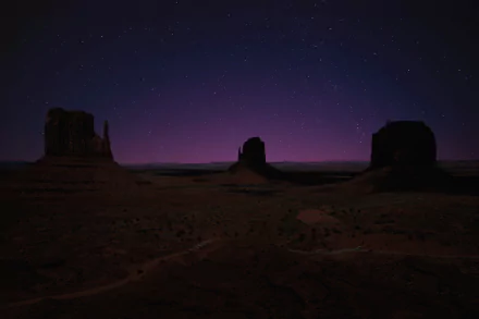 HD desktop wallpaper of a night sky filled with stars above a serene canyon landscape, showcasing nature's beauty.