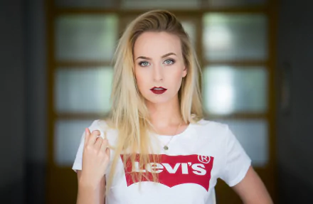 Blonde woman with blue eyes and bold lipstick poses confidently in a white Levi's shirt, captured in stunning 4K Ultra HD for a PC desktop wallpaper.