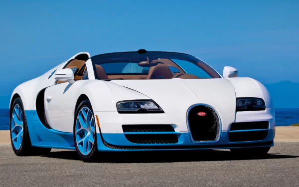 White Bugatti Veyron Grand Sport Vitesse supercar with blue accents parked by the sea, 4K Ultra HD PC desktop wallpaper background.