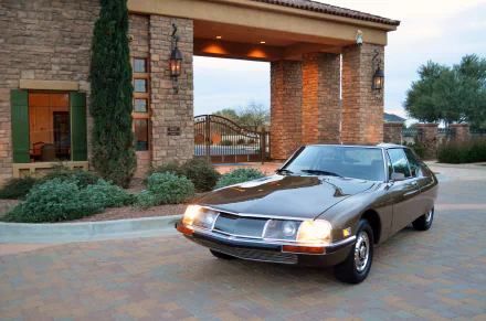 A classic Citroën SM 5-Speed car parked in front of a stone building, captured in 4K Ultra HD for a PC desktop wallpaper background.