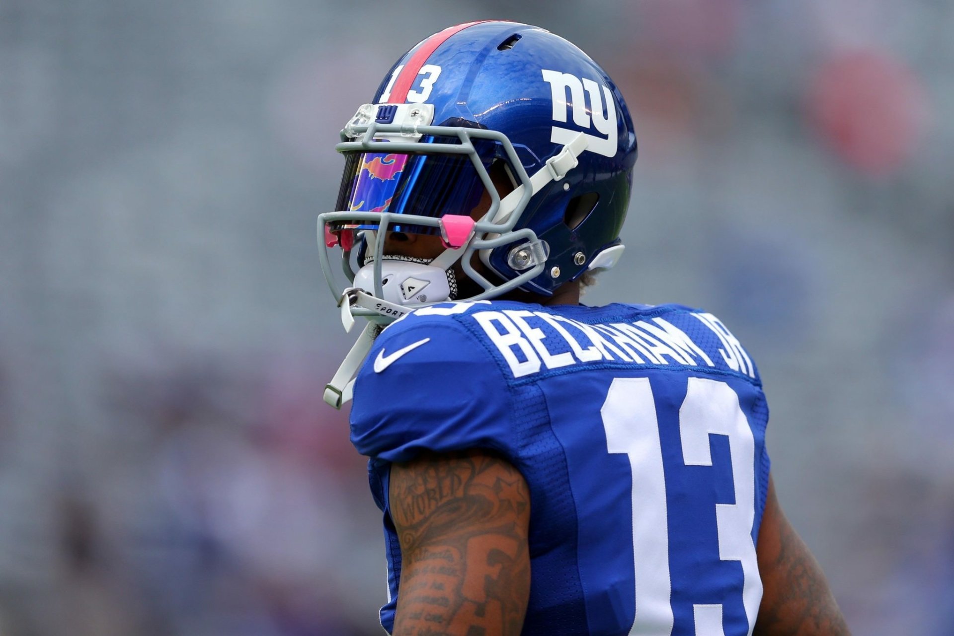 A New York Giants player in a blue #13 jersey on the field, serving as a HD desktop wallpaper and background.