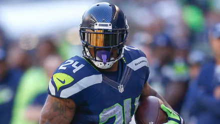 Seattle Seahawks player Marshawn Lynch, wearing number 24 jersey, featured in a vibrant HD desktop wallpaper.