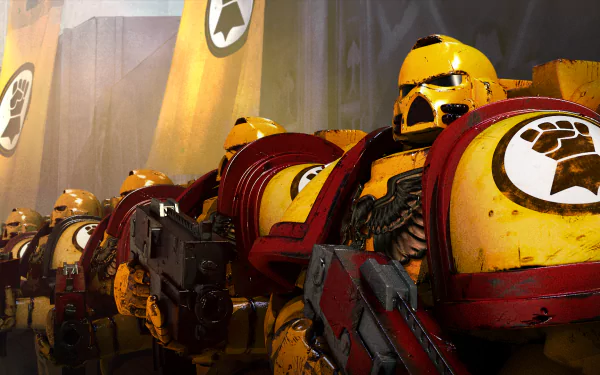 HD PC wallpaper featuring a squad of yellow-armored Space Marines from the Warhammer 40k video game, poised in battle-ready formation inside a futuristic setting.