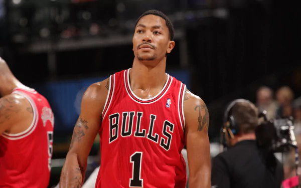HD wallpaper of Derrick Rose in a Chicago Bulls jersey, standing on the basketball court, providing an impactful background.