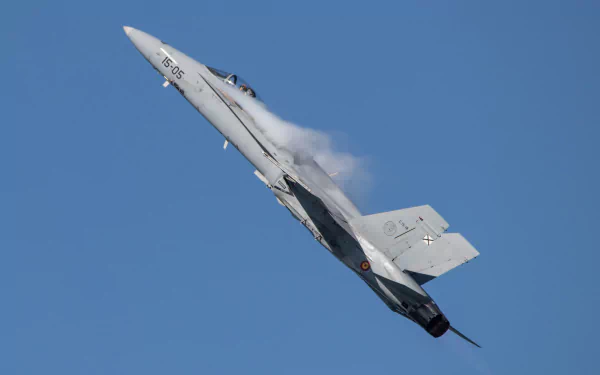 4K Ultra HD desktop wallpaper of a McDonnell Douglas F/A-18 Hornet jet fighter climbing with vapor trails against a clear blue sky.