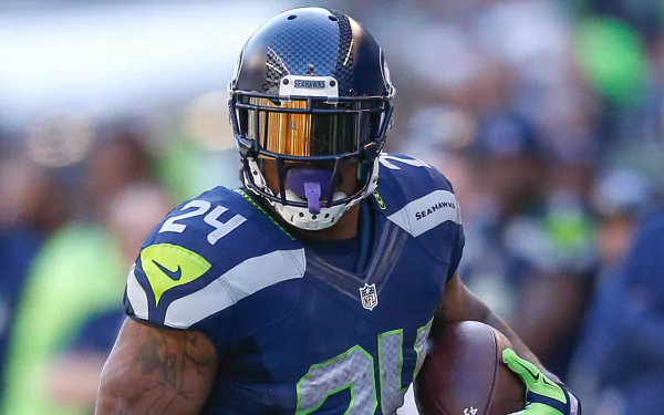Seattle Seahawks player Marshawn Lynch, wearing number 24 jersey, featured in a vibrant HD desktop wallpaper.