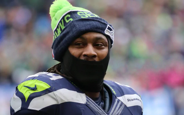 HD desktop wallpaper featuring Seattle Seahawks player Marshawn Lynch wearing team gear.