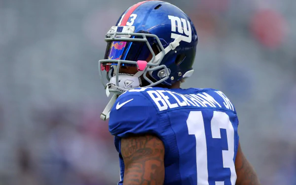 A New York Giants player in a blue #13 jersey on the field, serving as a HD desktop wallpaper and background.