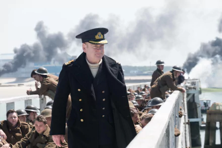 A scene from the movie Dunkirk featuring Kenneth Branagh in uniform, set as a HD desktop wallpaper and background. Smoke and soldiers are visible in the background.