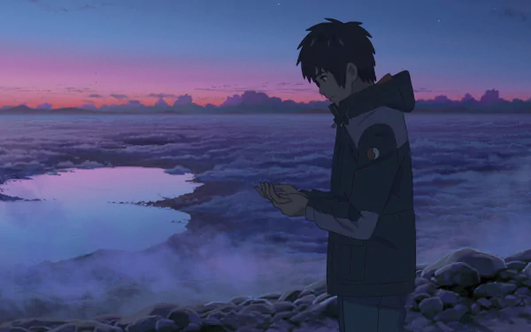 HD anime desktop wallpaper featuring Taki Tachibana from Your Name. standing on rocky terrain at dusk, holding a phone against a serene cloudy landscape backdrop.