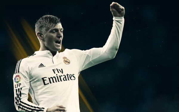 HD desktop wallpaper of Real Madrid C.F. midfielder Toni Kroos celebrating on the soccer field, wearing the team's white kit.