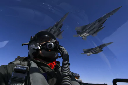 4K Ultra HD image of a military pilot in flight gear with three Rockwell B-1 Lancer bombers soaring against a clear blue sky, representing air force power.