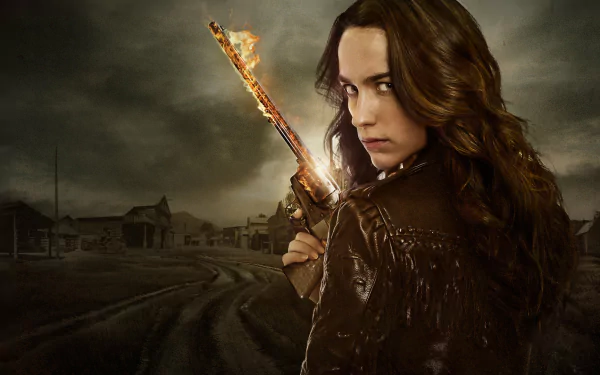 HD PC desktop wallpaper featuring Melanie Scrofano as Wynonna Earp, holding a glowing gun against a dark, stormy background from the TV show Wynonna Earp.