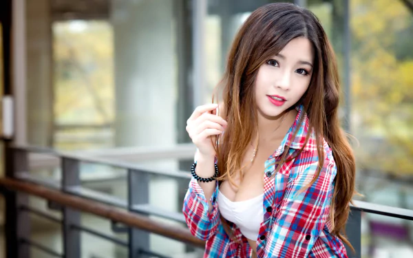 A high-definition wallpaper featuring an Asian brunette model with lipstick, posing indoors with a blurred background, showcasing depth of field.