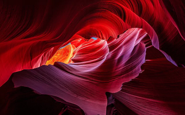 Vivid red and purple sandstone formations twisting in Antelope Canyon, showcasing the natural beauty of this stunning canyon in an HD PC desktop wallpaper.