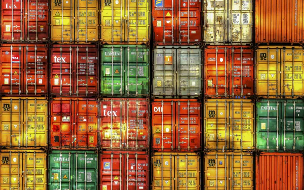 HD desktop wallpaper featuring a vibrant, colorful photo of stacked shipping containers in various hues, showcasing bold patterns and textures.