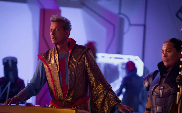 HD wallpaper of Jeff Goldblum as Grandmaster from the movie Thor: Ragnarok, featuring vibrant colors and a futuristic setting in the background.