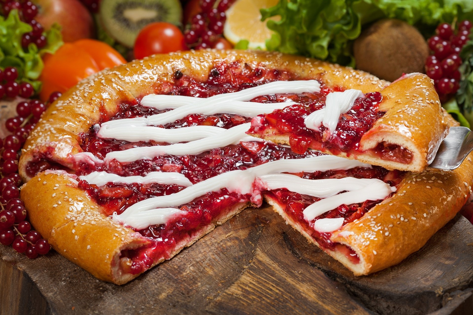 HD desktop wallpaper of a delicious berry pastry topped with currants and drizzled with icing. The pie is beautifully arranged with fresh fruits in a vibrant still life setting.