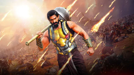 HD wallpaper of the movie Baahubali 2: The Conclusion featuring a warrior in armor holding a weapon amidst a fiery battlefield.