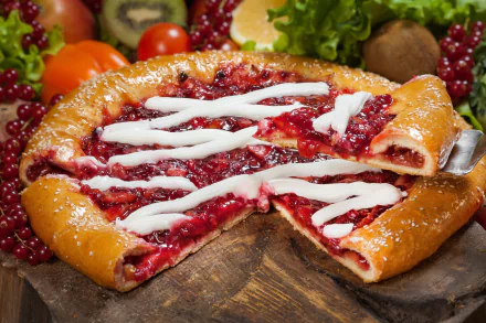 HD desktop wallpaper of a delicious berry pastry topped with currants and drizzled with icing. The pie is beautifully arranged with fresh fruits in a vibrant still life setting.
