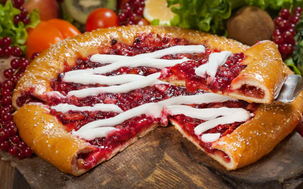 HD desktop wallpaper of a delicious berry pastry topped with currants and drizzled with icing. The pie is beautifully arranged with fresh fruits in a vibrant still life setting.