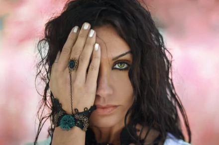 Close-up of a brunette woman with green eyes, featuring depth of field effect, captured in 4K Ultra HD for a striking PC desktop wallpaper background.