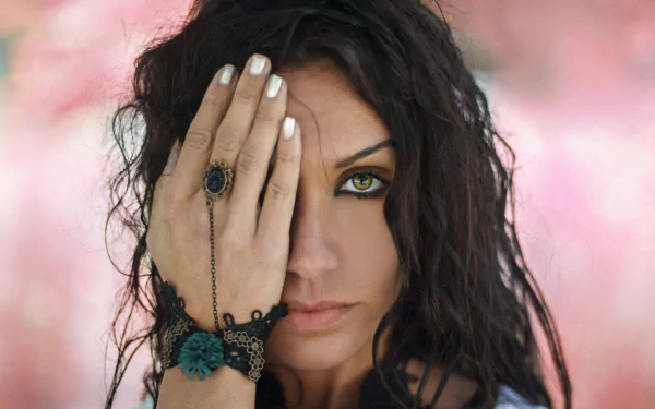 Close-up of a brunette woman with green eyes, featuring depth of field effect, captured in 4K Ultra HD for a striking PC desktop wallpaper background.