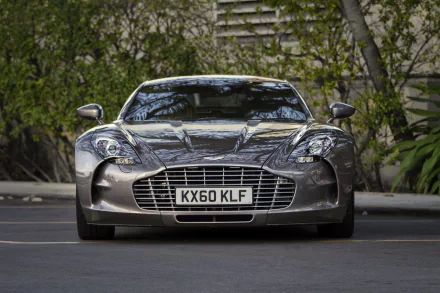 Front view of a silver Aston Martin One-77 coupé supercar, parked vehicle with chrome grille and license plate visible; HD PC desktop wallpaper/background.