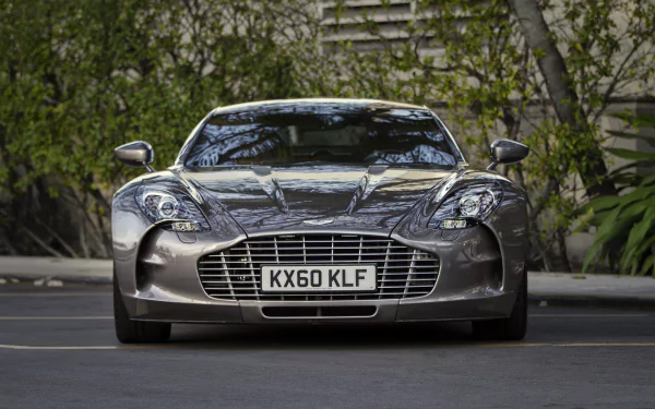 Front view of a silver Aston Martin One-77 coupé supercar, parked vehicle with chrome grille and license plate visible; HD PC desktop wallpaper/background.