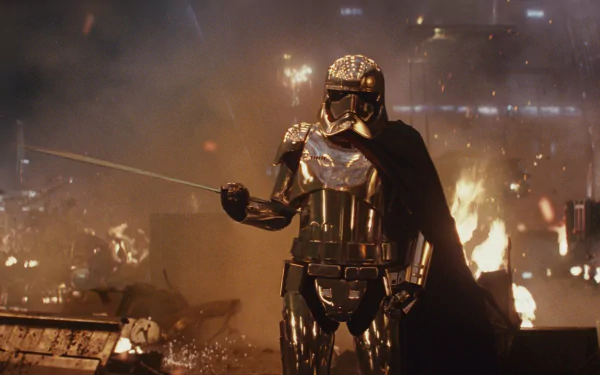 Captain Phasma, portrayed by Gwendoline Christie, stands in reflective armor amid destruction in a dramatic scene from Star Wars: The Last Jedi.