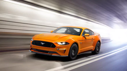 HD desktop wallpaper featuring an orange Ford Mustang GT supercar speeding through a blurred tunnel.