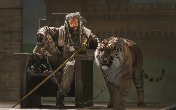 Ezekiel from The Walking Dead sits confidently with his chained tiger, Shiva, in a dramatic 4K Ultra HD TV show wallpaper background.