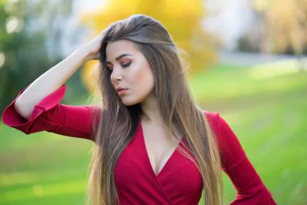 A brunette woman model with long hair poses outdoors in soft natural light, captured in 4K Ultra HD with a shallow depth of field for a PC desktop wallpaper.