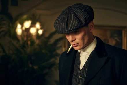 Thomas Shelby, played by Cillian Murphy in the TV show Peaky Blinders, dressed in period attire with a cigarette, captured in a 4K Ultra HD desktop wallpaper.
