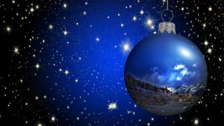 A blue Christmas ornament reflecting a snowy winter town, set against a starry night sky with falling snowflakes, creating a festive holiday desktop wallpaper.