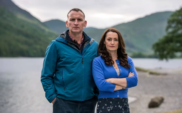 The A Word series characters posing confidently before a lake and mountains, as an HD desktop wallpaper background.