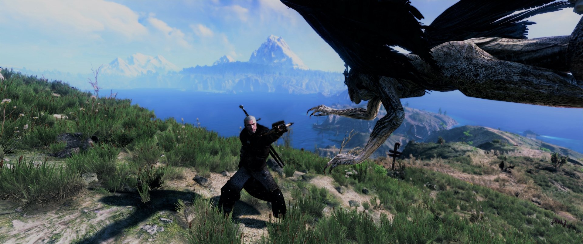 HD fantasy PC wallpaper from The Witcher 3: Wild Hunt, featuring Geralt facing a griffin against a scenic mountainous landscape.