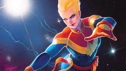 HD comic-style PC desktop wallpaper featuring Carol Danvers as Captain Marvel, depicted in vibrant colors with a dynamic cosmic background.