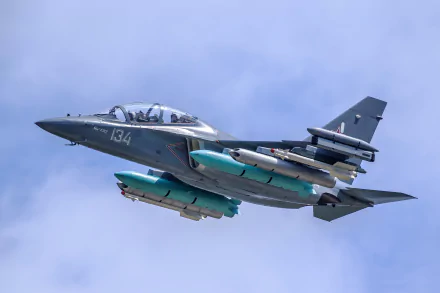 HD desktop wallpaper featuring a Yakovlev Yak-130 military jet fighter warplane in flight against a clear blue sky.