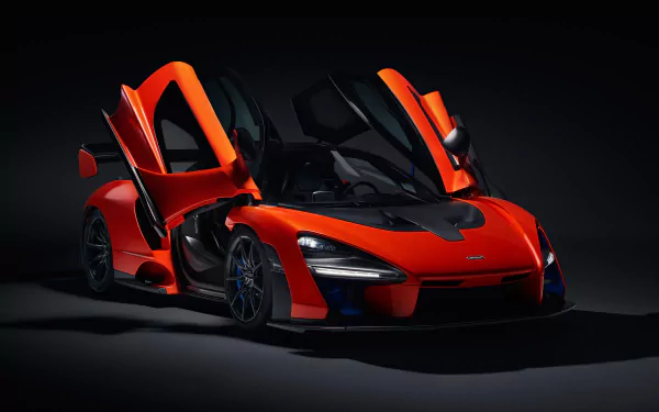 A striking red McLaren Senna supercar with open doors showcased against a dark background in 4K Ultra HD, designed as a PC desktop wallpaper and background.