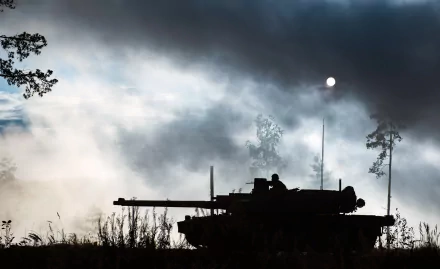 Silhouette of an AMX Leclerc military tank against a smoky sky, captured as an HD PC desktop wallpaper and background.